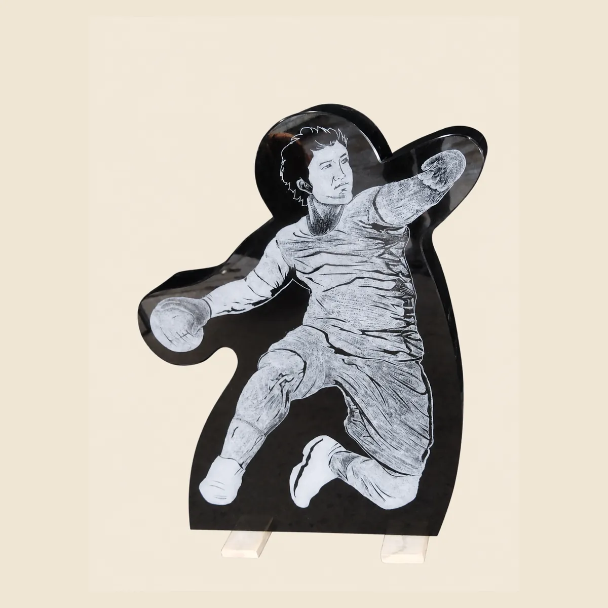 Custom-cut black granite silhouette of a basketball player, laser etched
