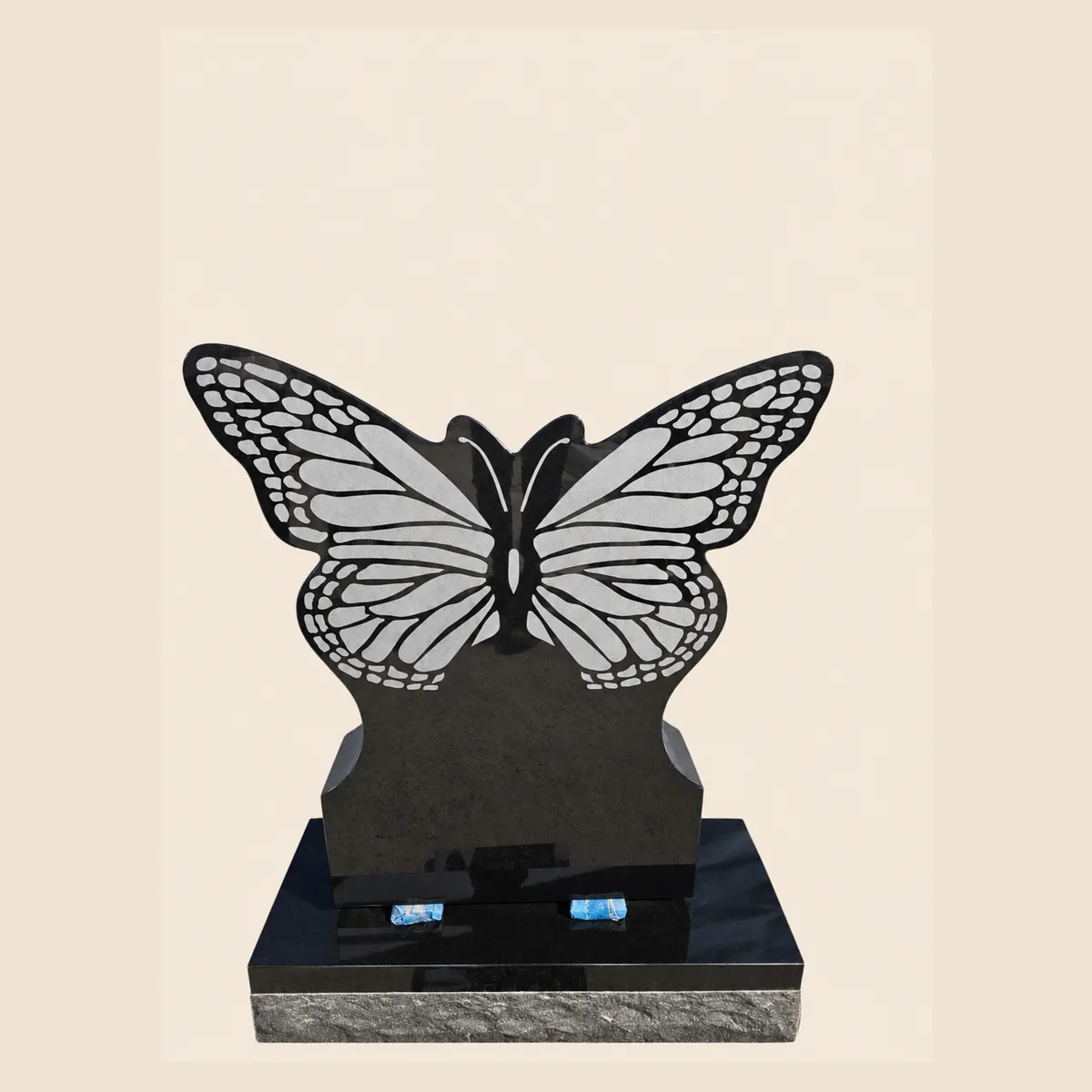 Black granite butterfly-shaped memorial with laser-etched wings