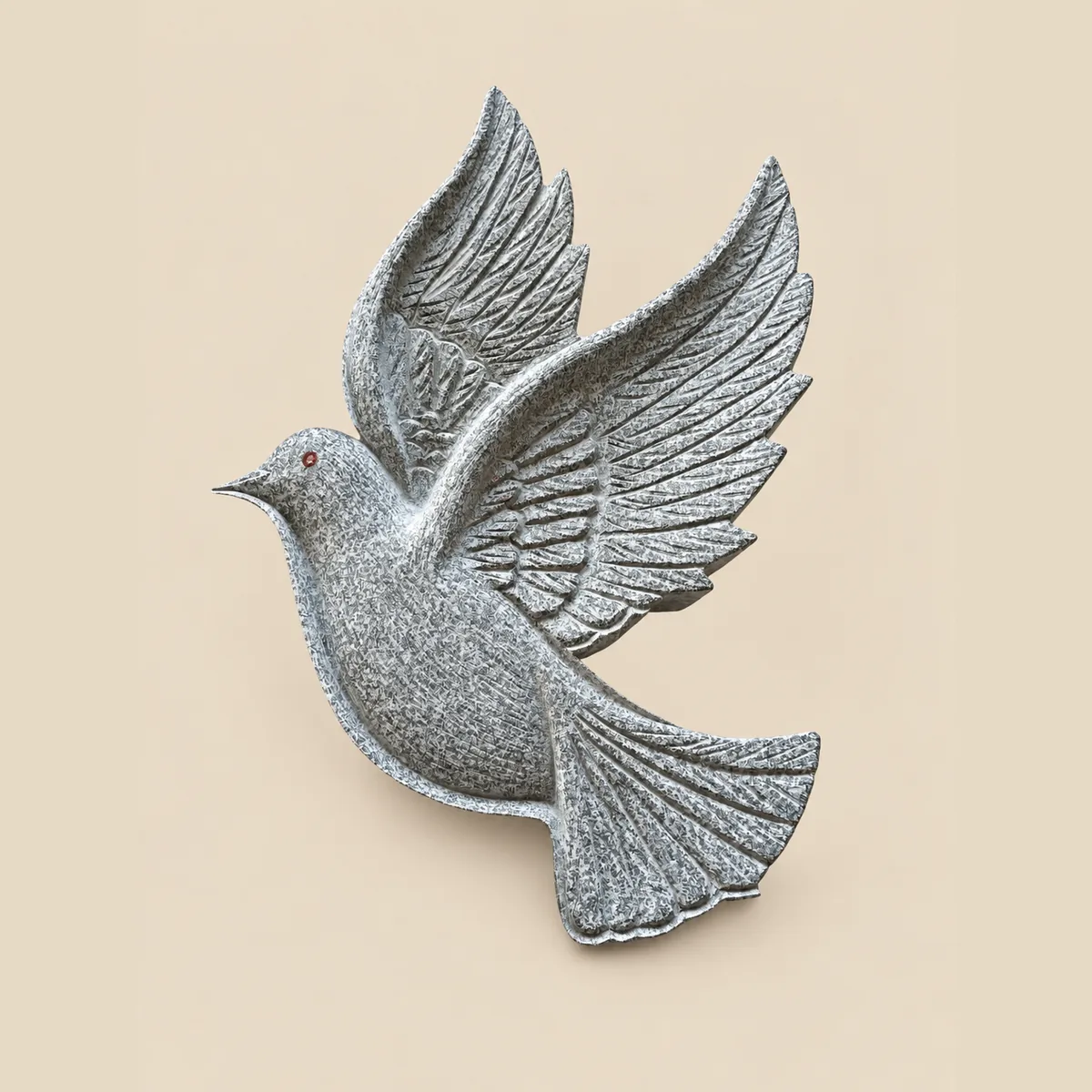 Dove in flight carved in grey granite