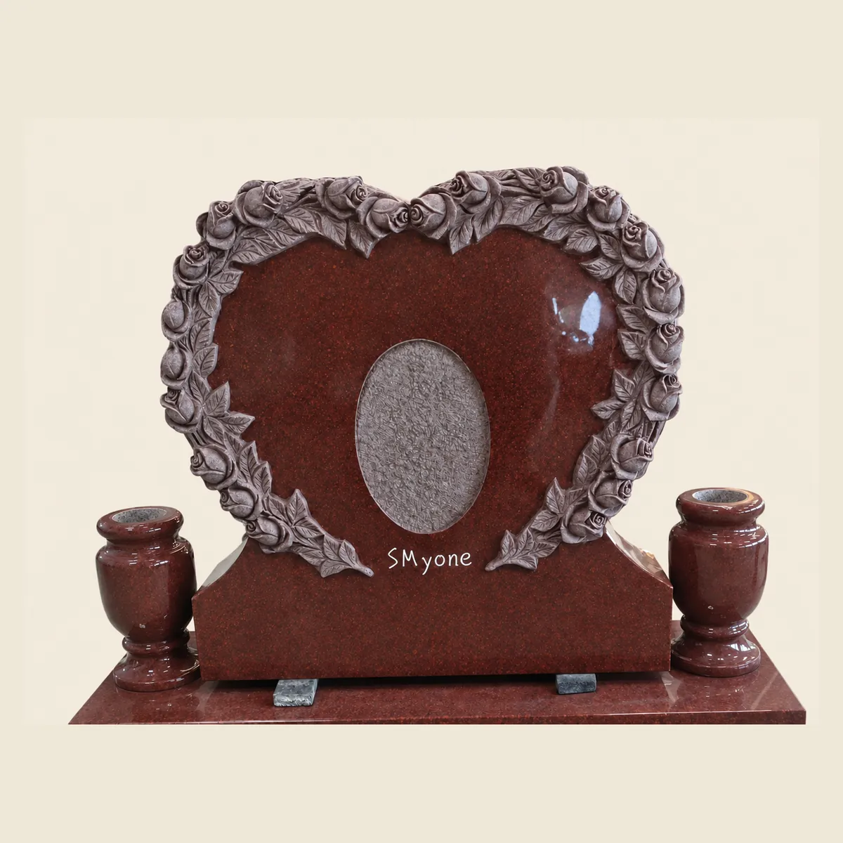 Ruby Red granite heart with a carved rose wreath, photo recess and matching vases