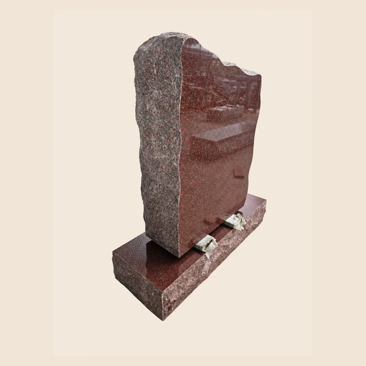 Multicolour Red rock-pitched upright with a polished face on a matching base